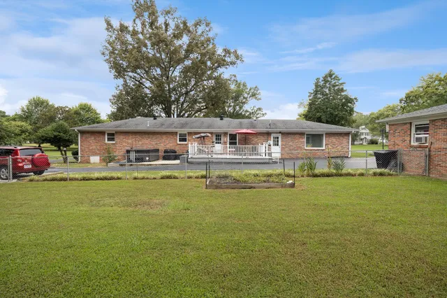 a front view of a house with swimming pool having outdoor seating