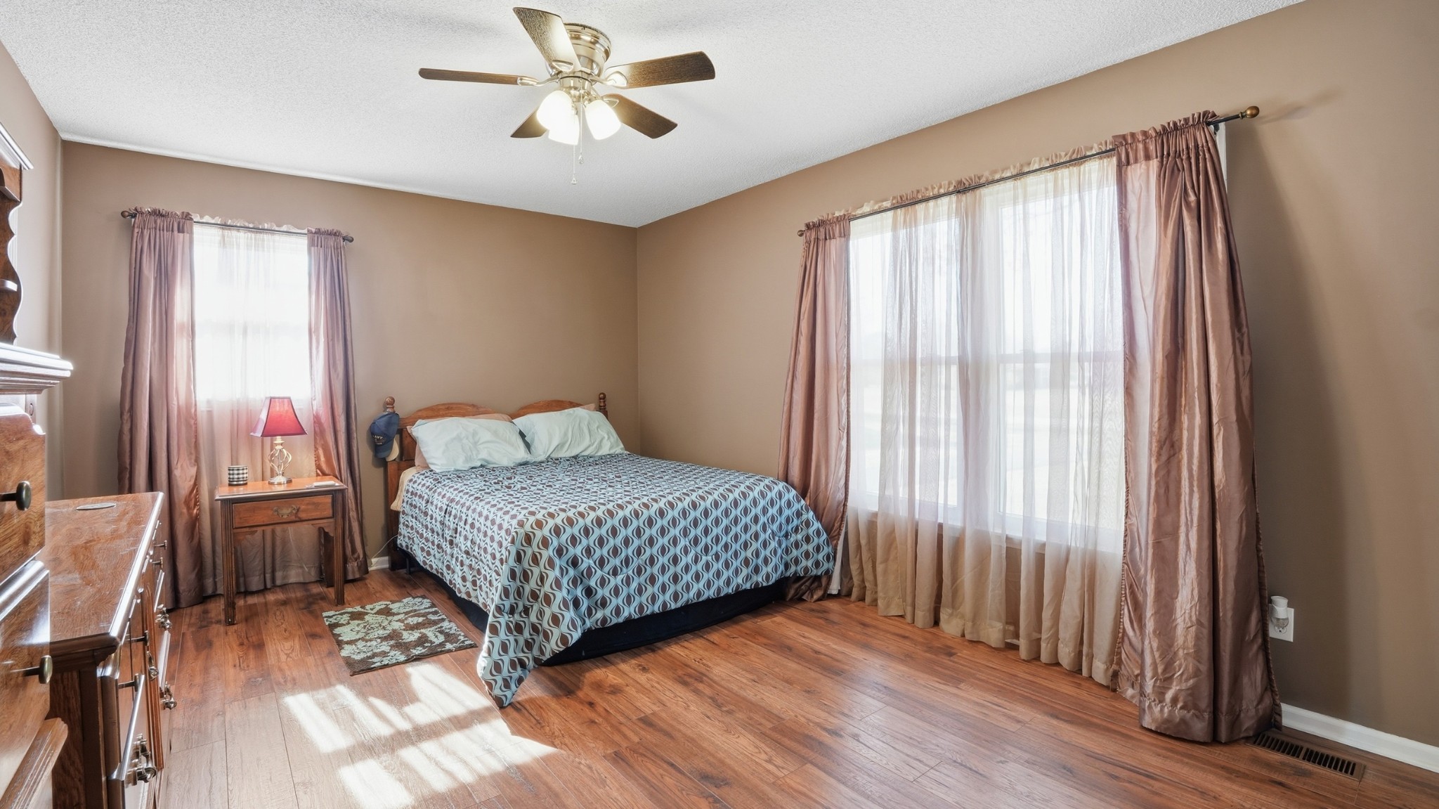 509 12 Oaks Road Tullahoma, TN 37388 - Photo 34 of 60 a bedroom with a large bed and a chandelier