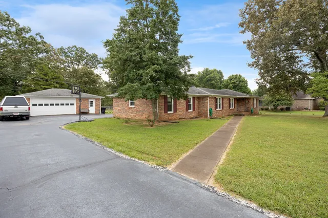 a view of house with outdoor space and parking