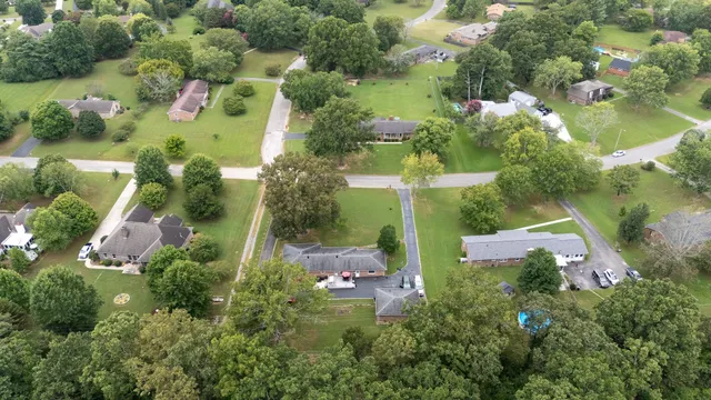 an aerial view of residential house with outdoor space and swimming pool