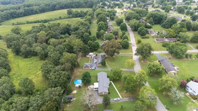 an aerial view of residential houses with outdoor space and street view