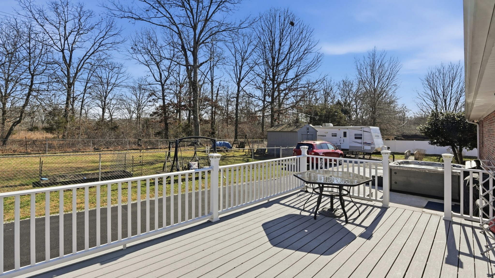 509 12 Oaks Road Tullahoma, TN 37388 - Photo 43 of 60 a view of a deck with couches table and chairs and wooden floor