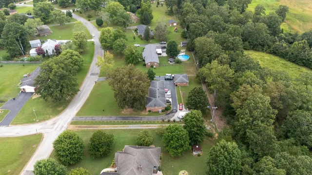 an aerial view of a house with a yard