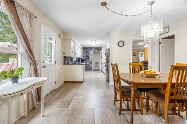 a view of a dining room with furniture and a chandelier