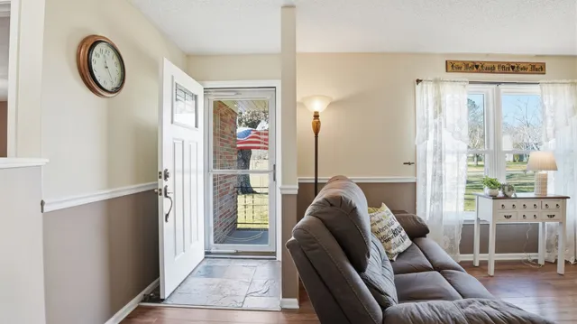 a kitchen with granite countertop white cabinets and stainless steel appliances
