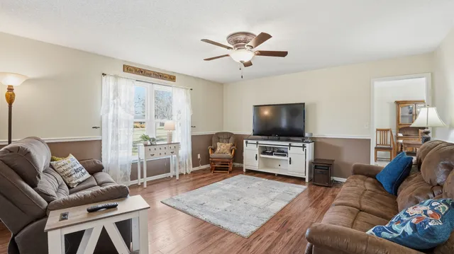 a kitchen with stainless steel appliances granite countertop a stove a refrigerator and a white cabinets