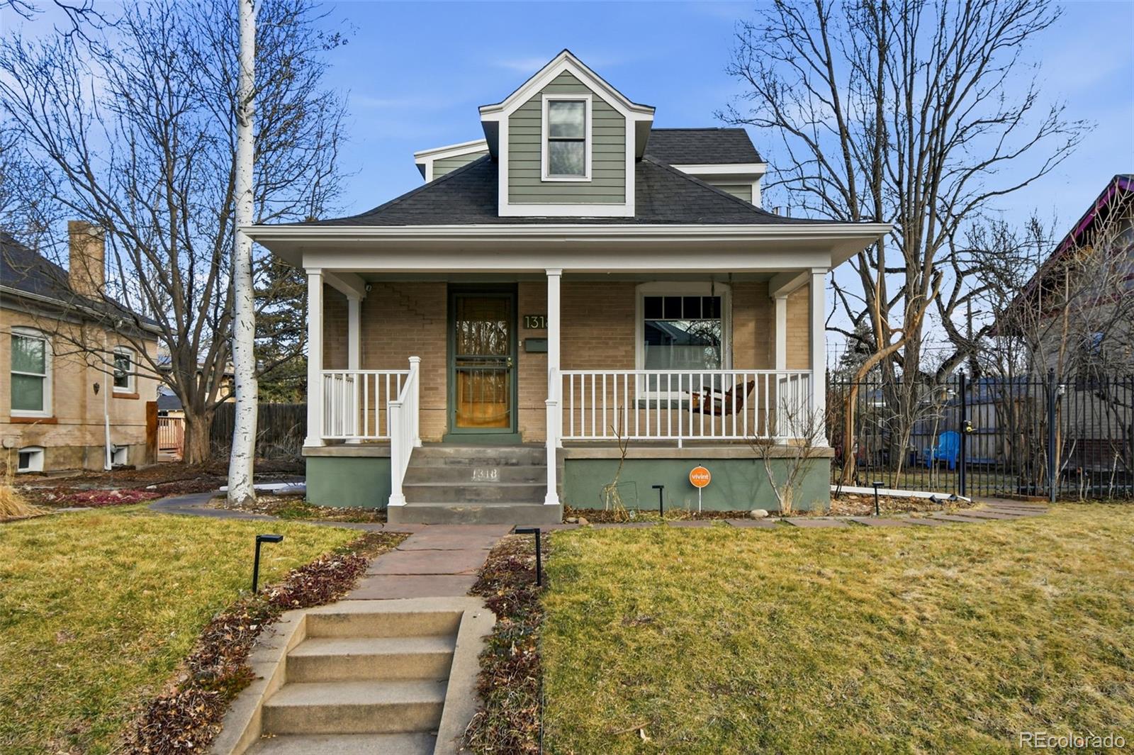 1318 South York Street Denver, CO 80210 - Photo 1 of 49 a front view of a house with a yard