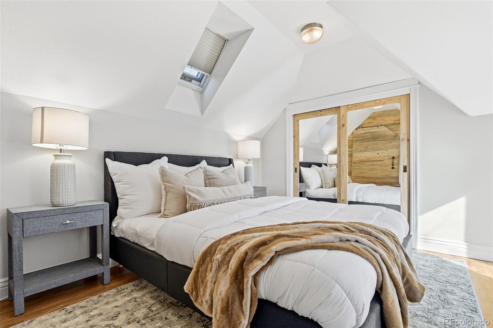 1318 South York Street Denver, CO 80210 - Photo 16 of 49 a bedroom with a bed and wooden floor