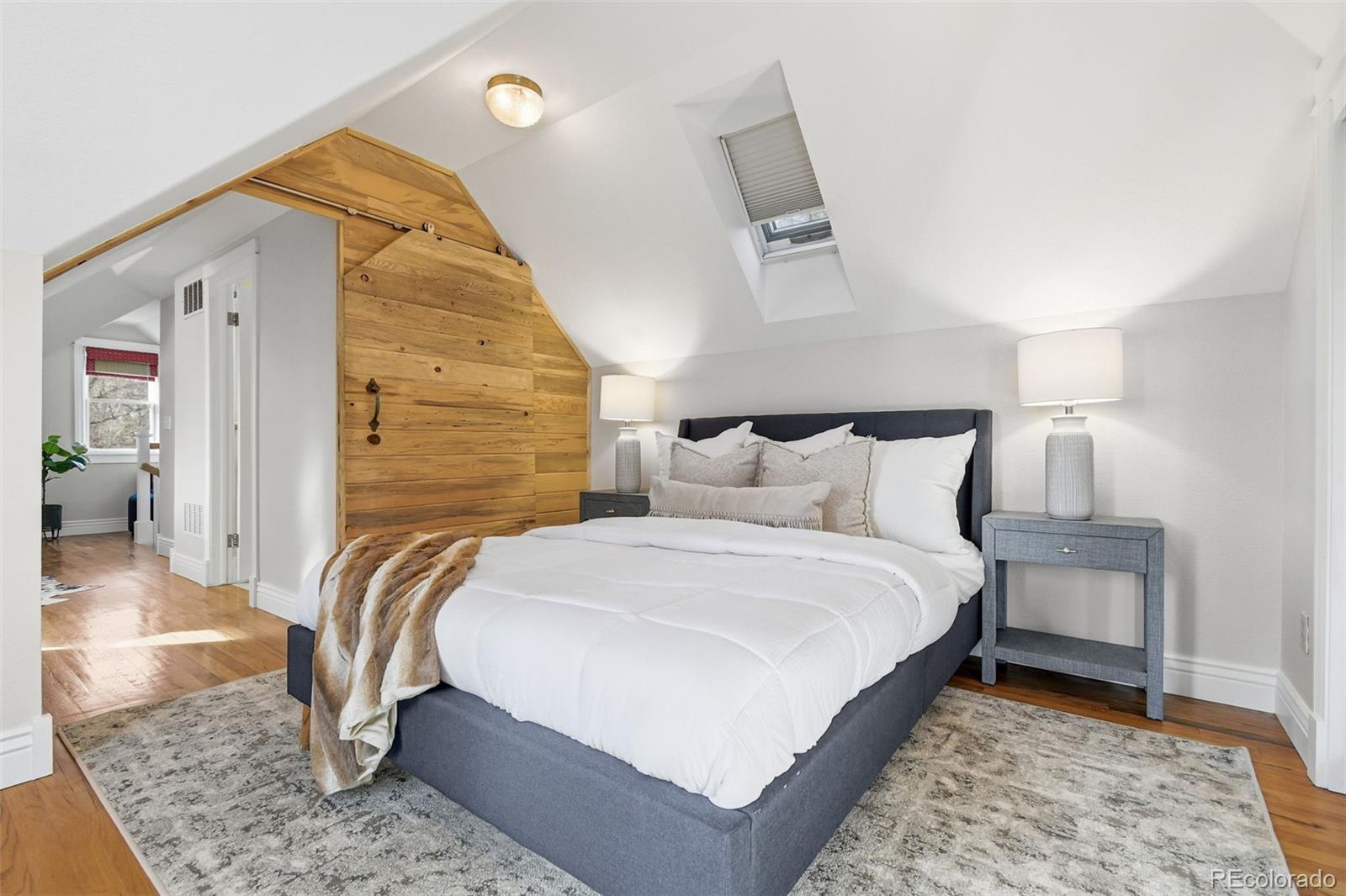 1318 South York Street Denver, CO 80210 - Photo 17 of 49 a bed room with a bed and a mirror