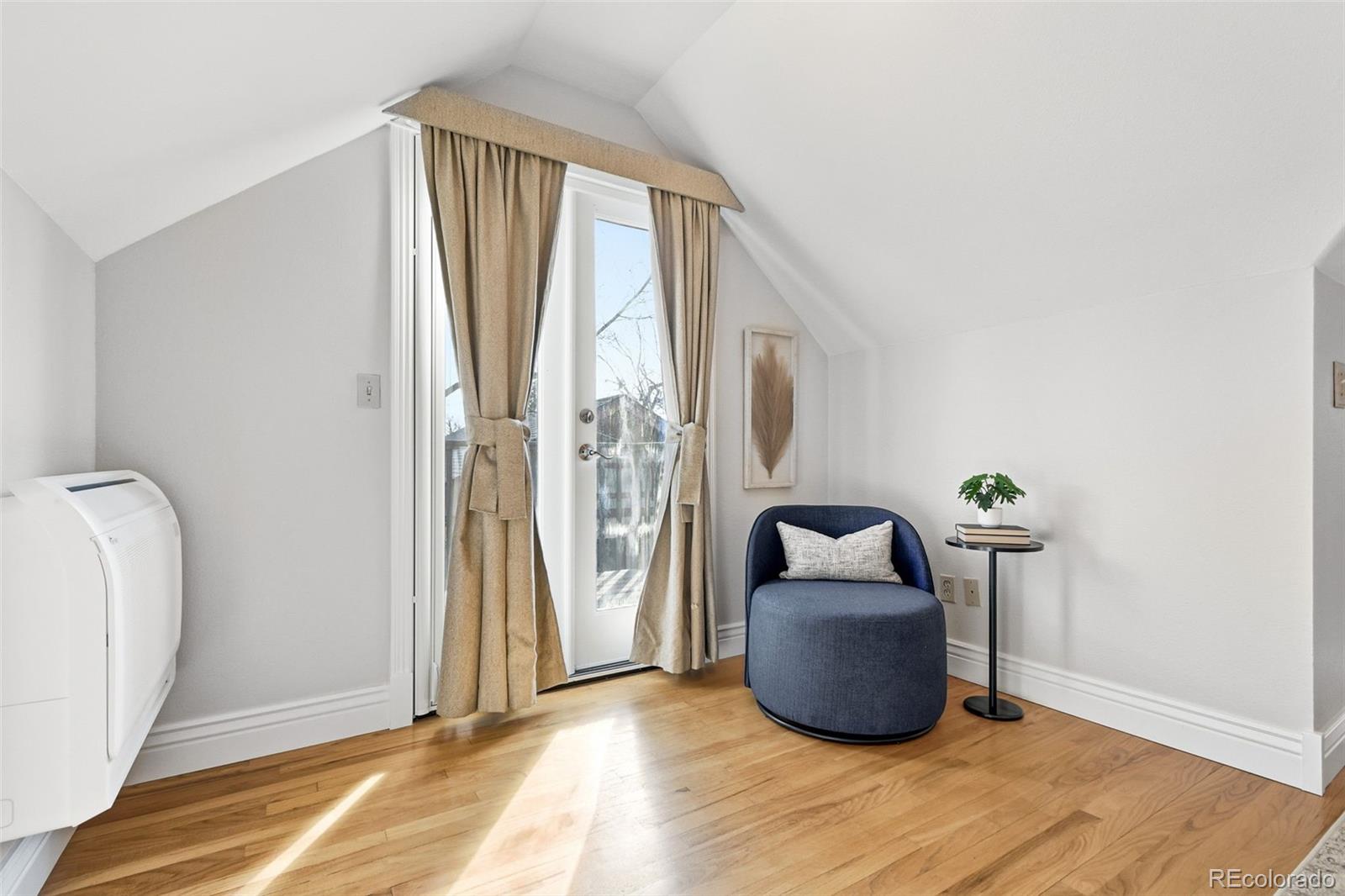 1318 South York Street Denver, CO 80210 - Photo 18 of 49 a room with hard wood floor and a window