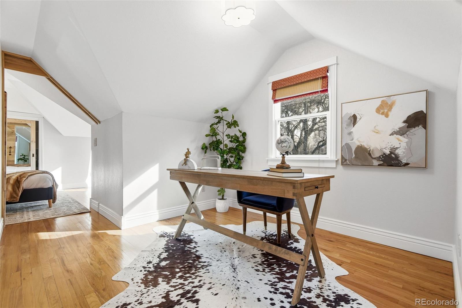 1318 South York Street Denver, CO 80210 - Photo 19 of 49 a living room with furniture and a wooden floor
