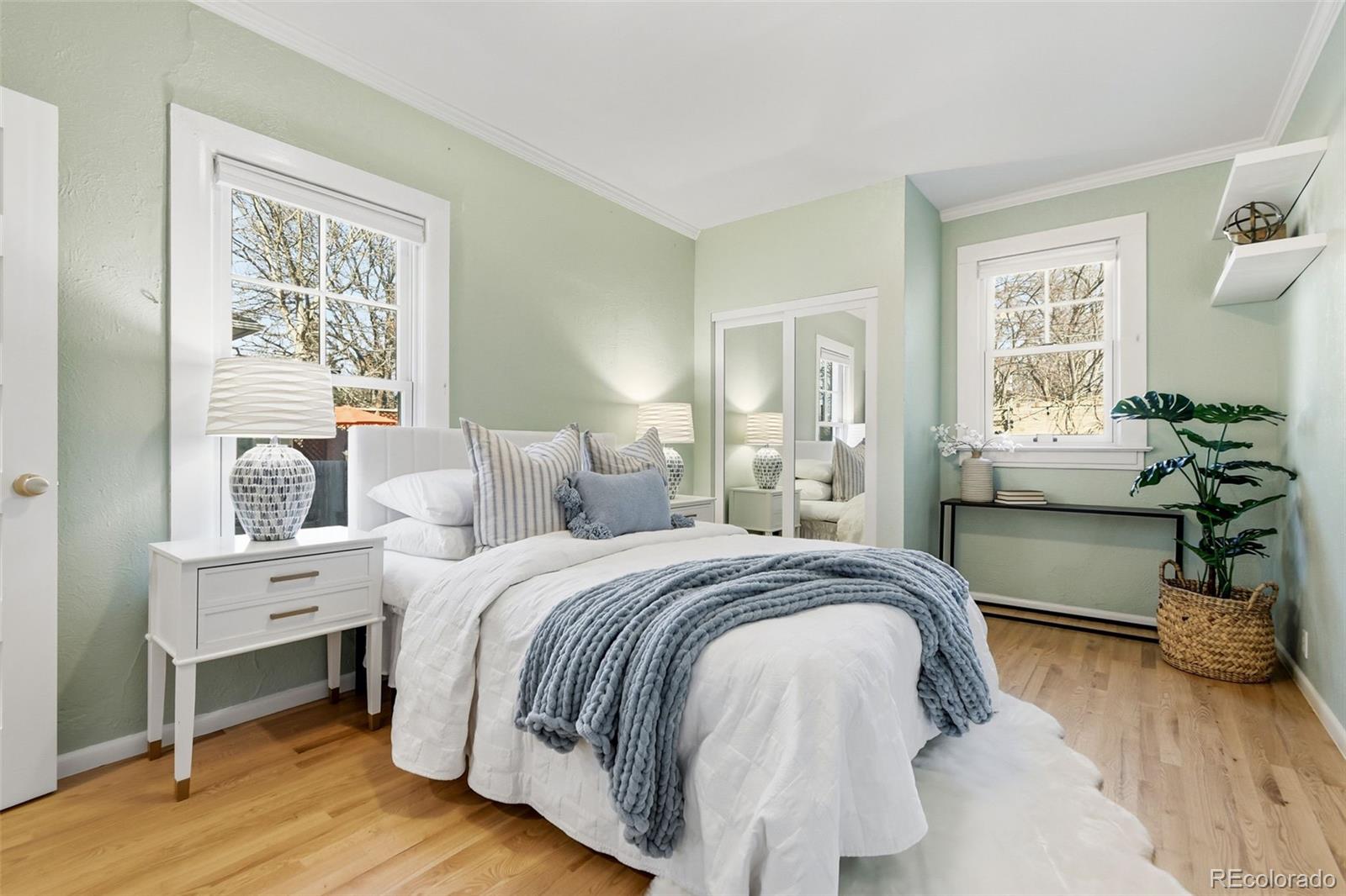 1318 South York Street Denver, CO 80210 - Photo 25 of 49 a spacious bedroom with a bed and wooden floor