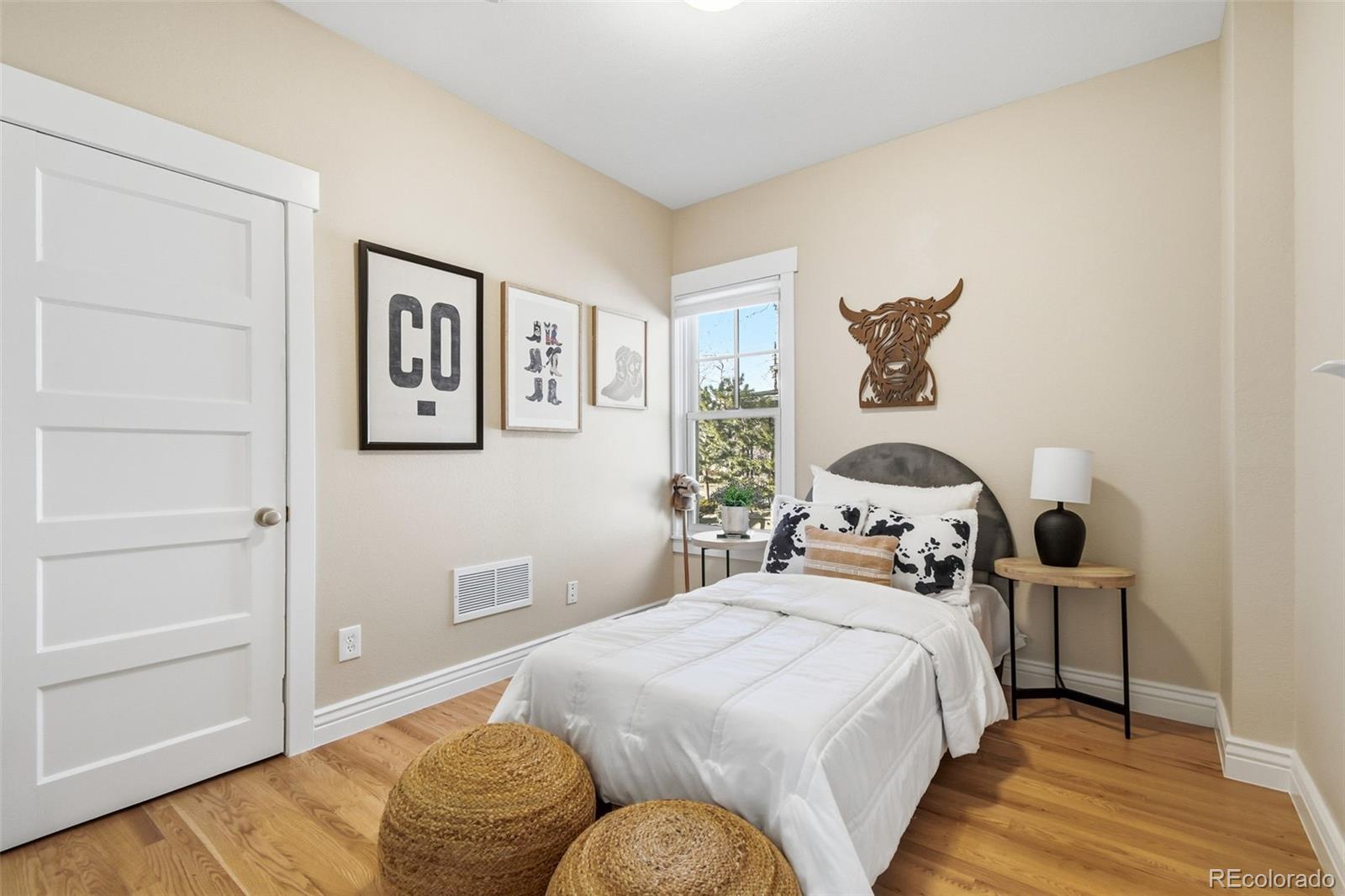 1318 South York Street Denver, CO 80210 - Photo 28 of 49 a bedroom with a bed and wooden floor
