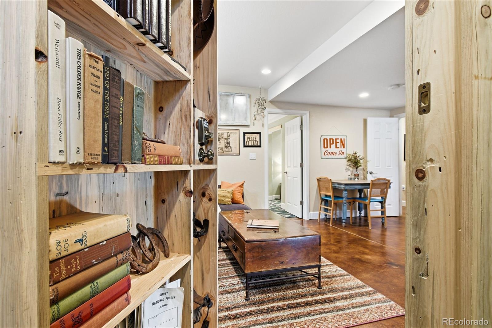 1318 South York Street Denver, CO 80210 - Photo 32 of 49 a living room with furniture a flat screen tv and a table