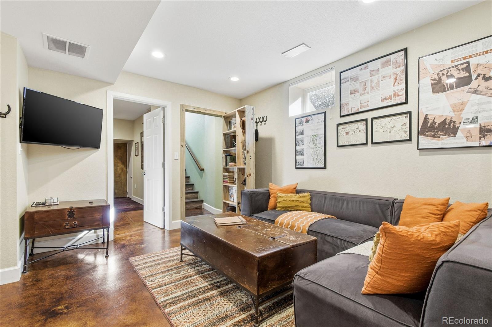 1318 South York Street Denver, CO 80210 - Photo 33 of 49 a living room with furniture and a flat screen tv