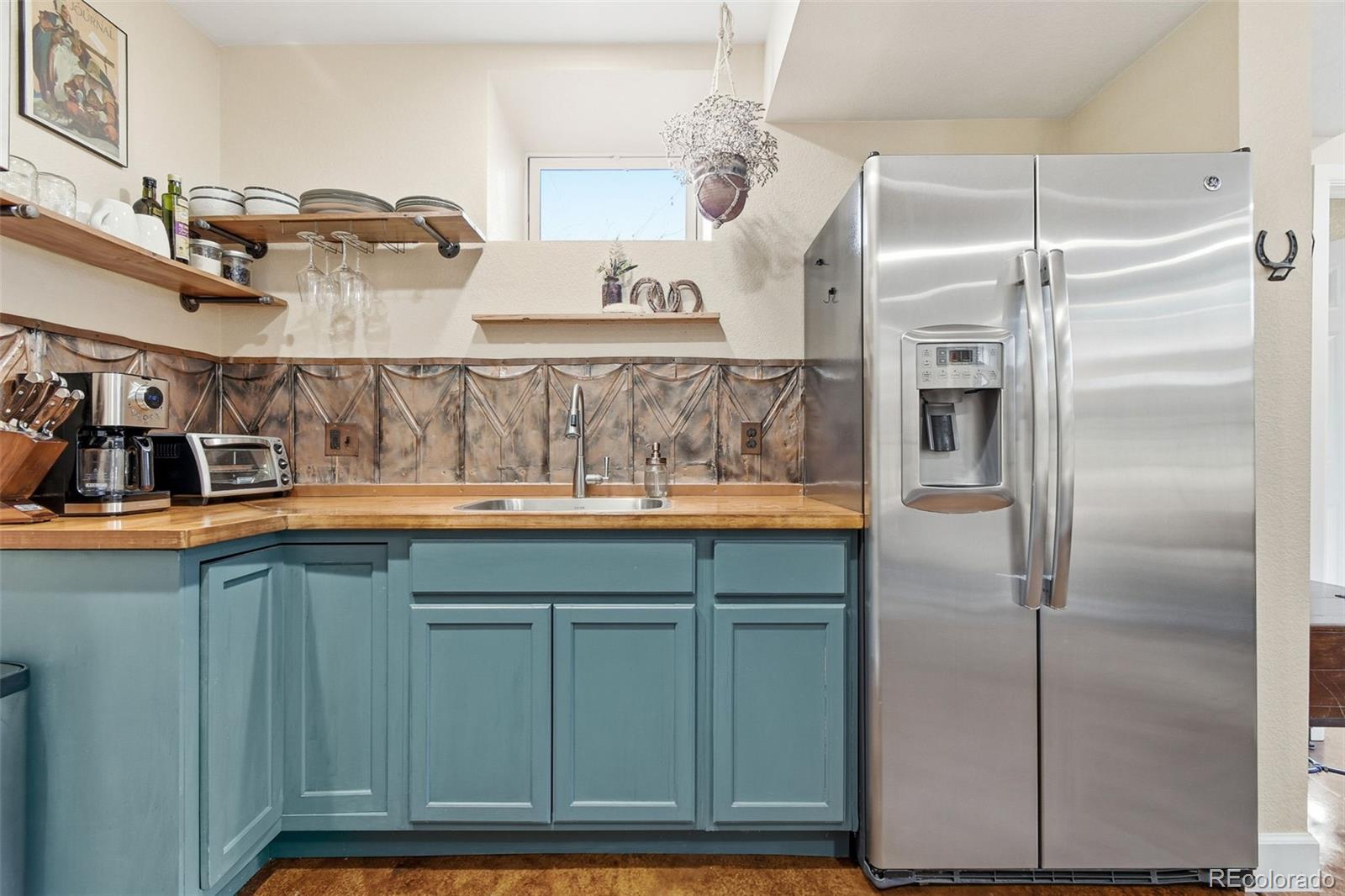 1318 South York Street Denver, CO 80210 - Photo 37 of 49 a kitchen with cabinets and stainless steel appliances