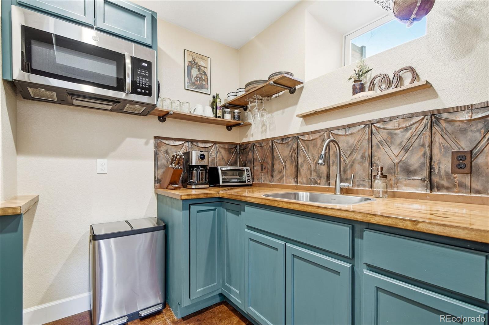 1318 South York Street Denver, CO 80210 - Photo 38 of 49 a kitchen with stainless steel appliances a sink and cabinets