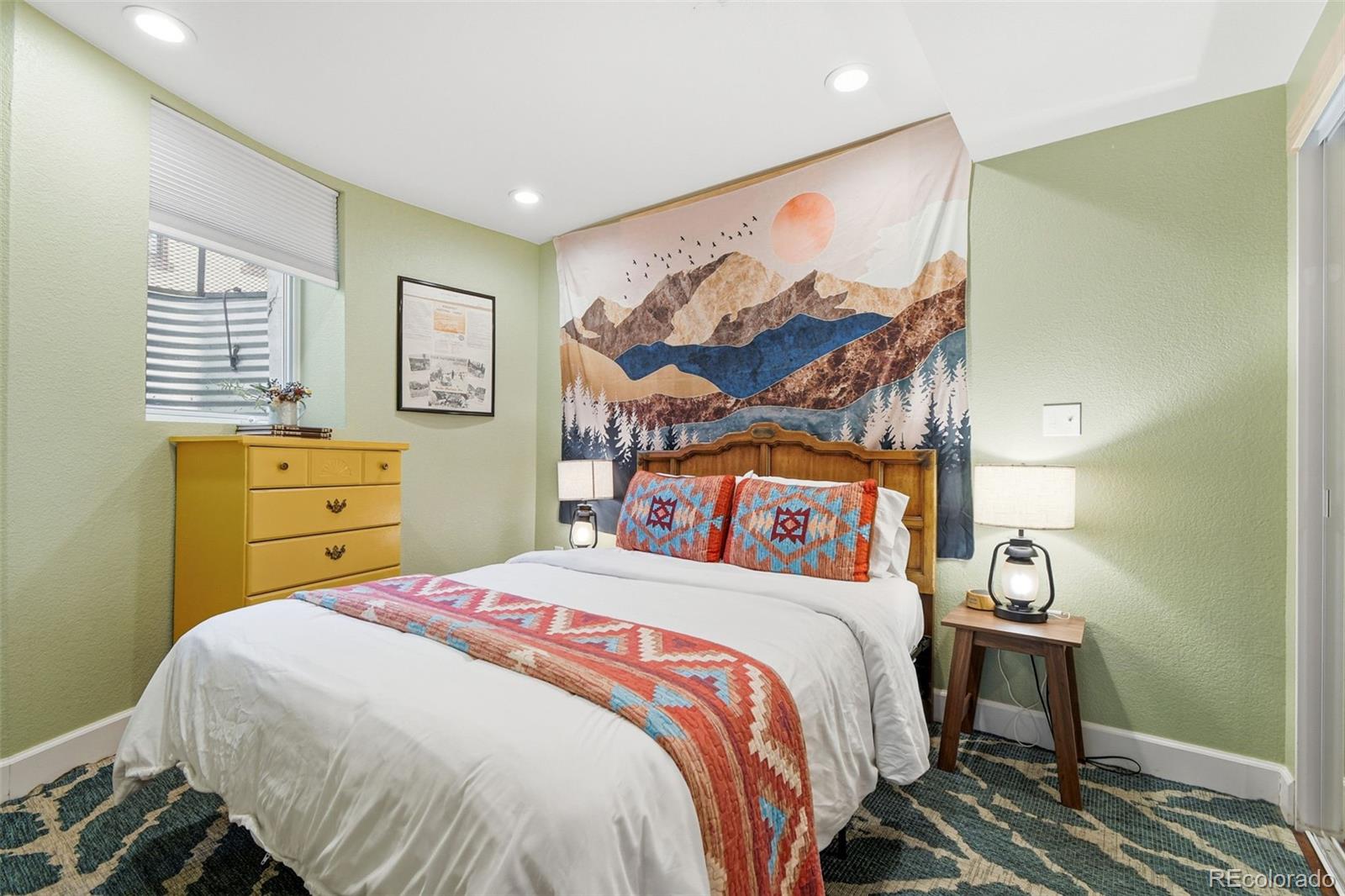 1318 South York Street Denver, CO 80210 - Photo 39 of 49 a bedroom with a bed and painting on the wall