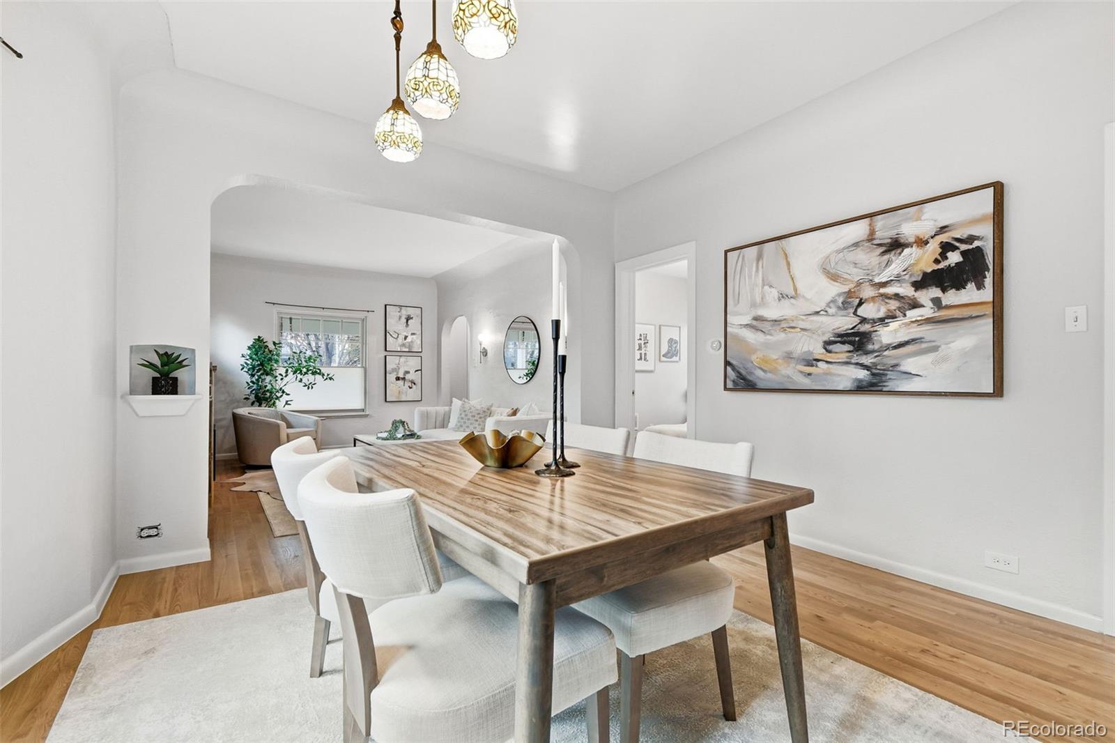 1318 South York Street Denver, CO 80210 - Photo 10 of 49 a view of a dining room with furniture and wooden floor