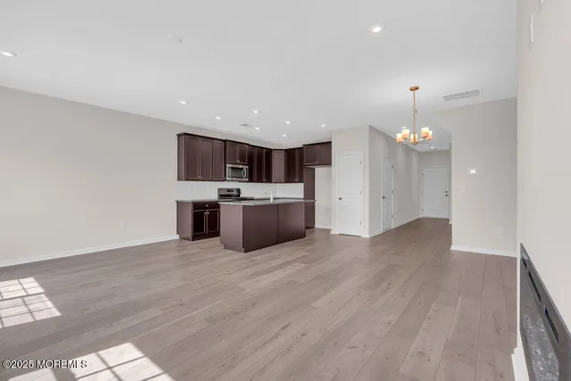 a view of a kitchen with a sink cabinets and wooden floor