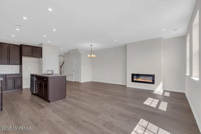 a view of kitchen with stainless steel appliances granite countertop a refrigerator a sink and a stove