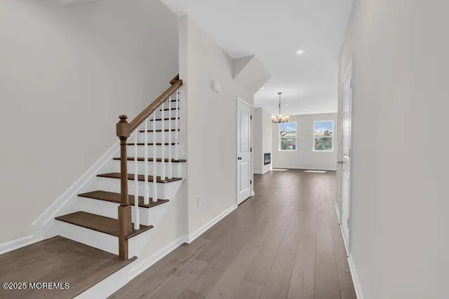 a view of a hallway with wooden floor and entryway