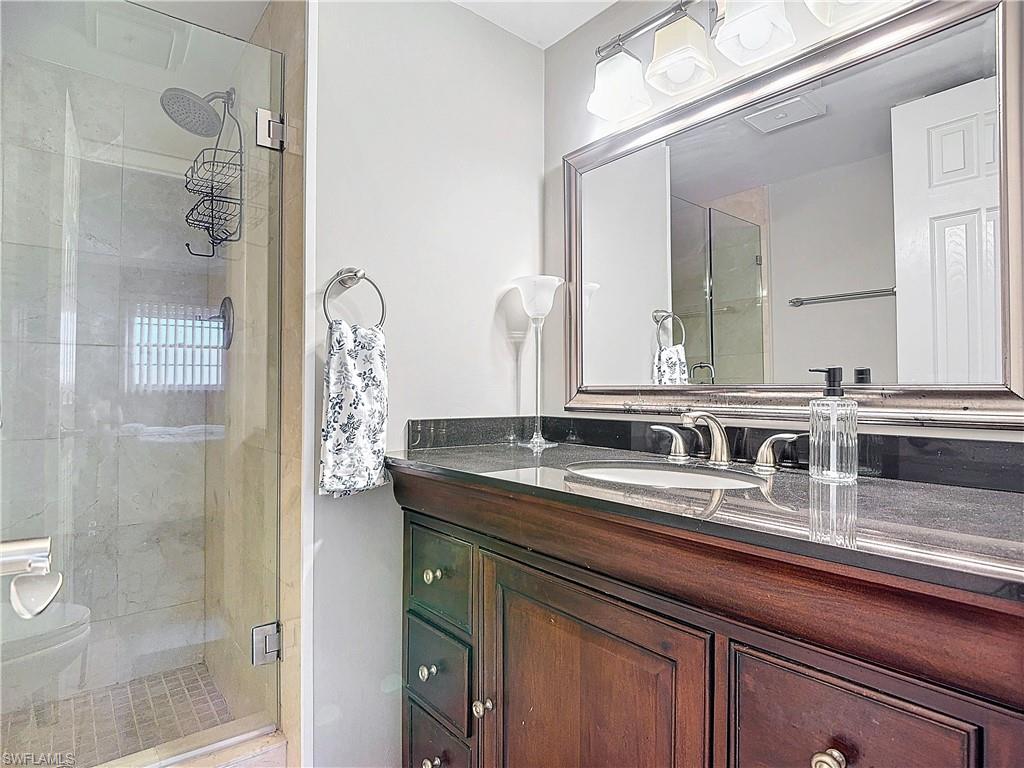 175 Turtle Lake Court, Unit 310 Naples, FL 34105 - Photo 22 of 34 Bathroom featuring walk in shower and vanity