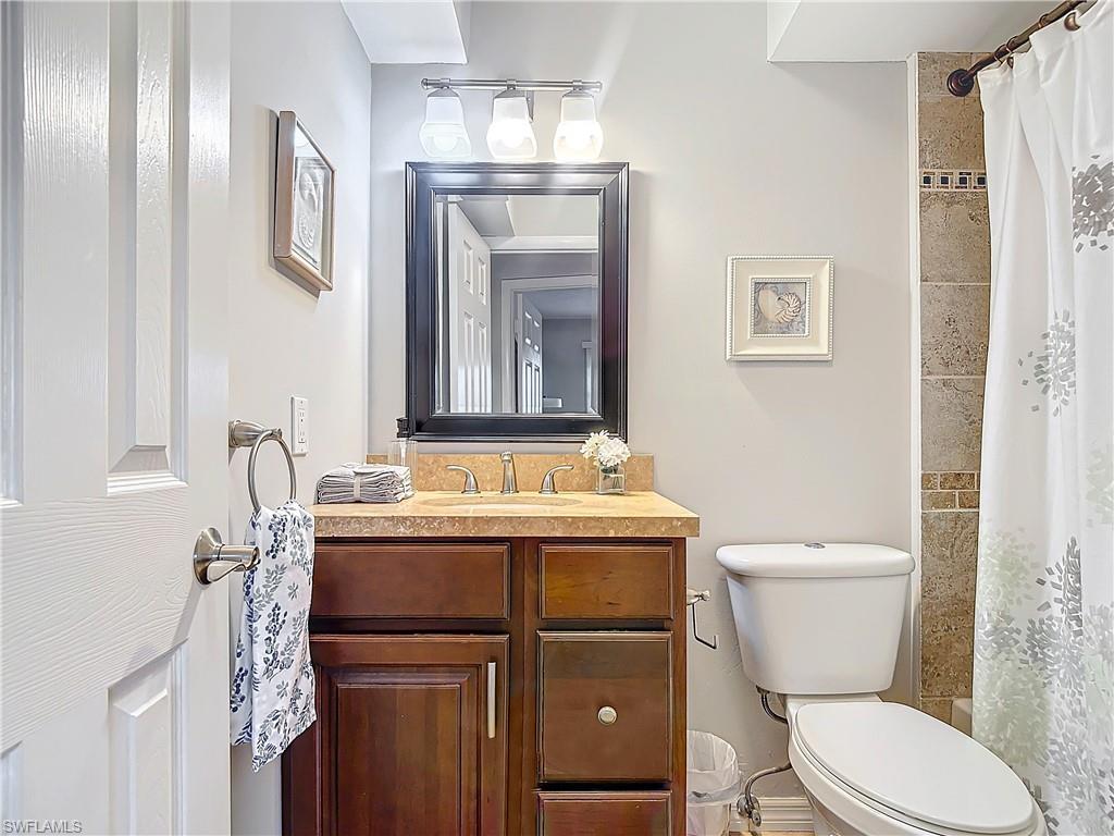 175 Turtle Lake Court, Unit 310 Naples, FL 34105 - Photo 26 of 34 Full bathroom with vanity, shower / bath combination with curtain, and toilet