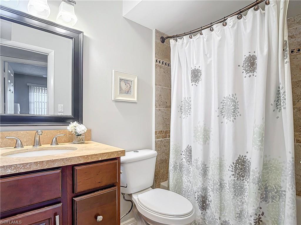 175 Turtle Lake Court, Unit 310 Naples, FL 34105 - Photo 27 of 34 Full bathroom with shower / bath combination with curtain, vanity, and toilet