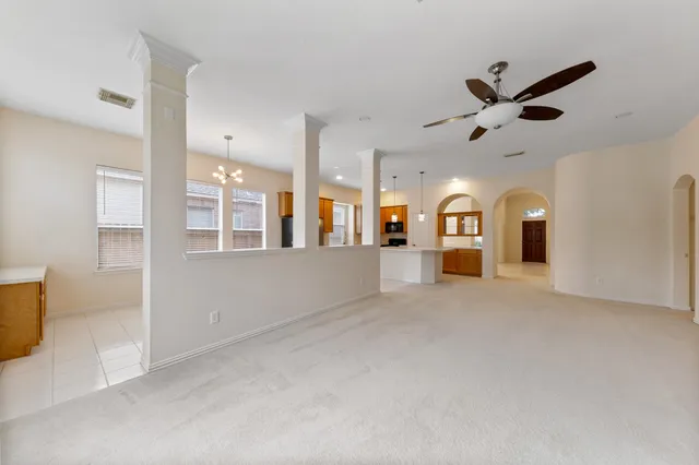 a view of a livingroom with a ceiling fan and window