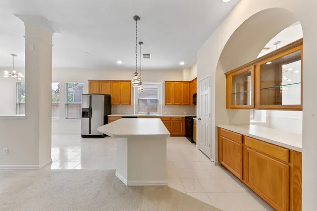 a large kitchen with stainless steel appliances kitchen island a large counter top and a view of living room