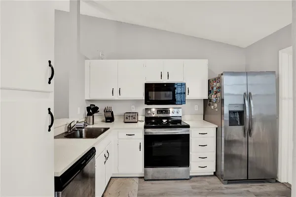 a kitchen with stainless steel appliances a refrigerator stove and microwave