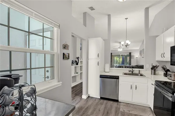 a kitchen with cabinets a sink and appliances