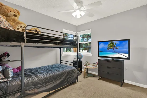 a bedroom with furniture and a flat screen tv