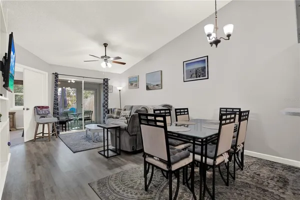 a view of a dining room with furniture wooden floor and chandelier