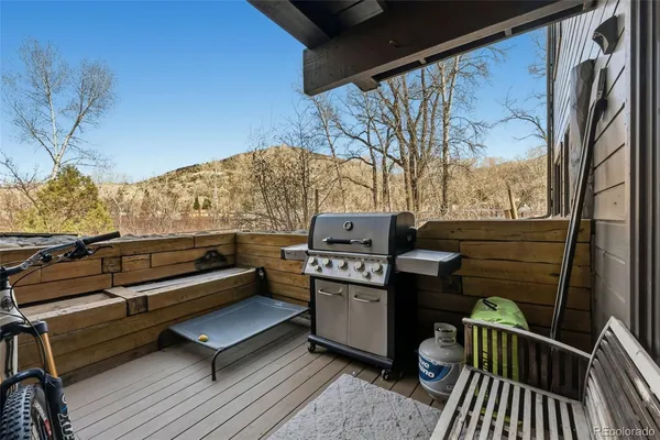 a view of a roof deck with couches and wooden floor