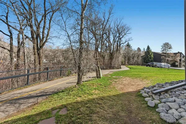 a view of a backyard with large trees