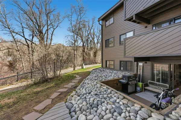 a wooden bench sitting in front of a house
