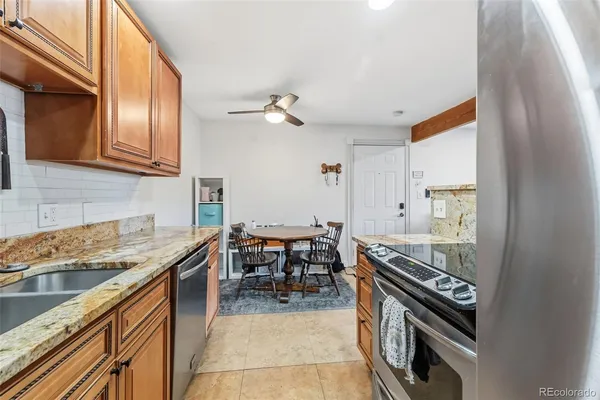 a kitchen with a stove sink and cabinets