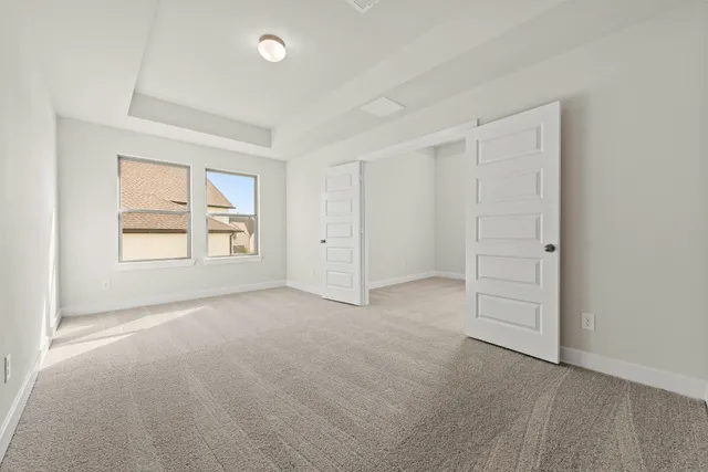 an empty room with windows and closet