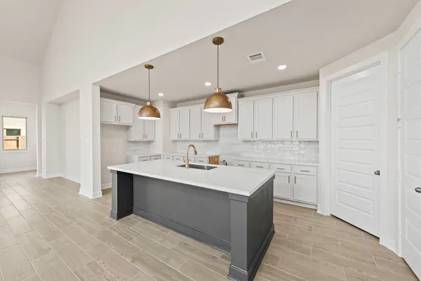 a kitchen with a sink window and cabinets