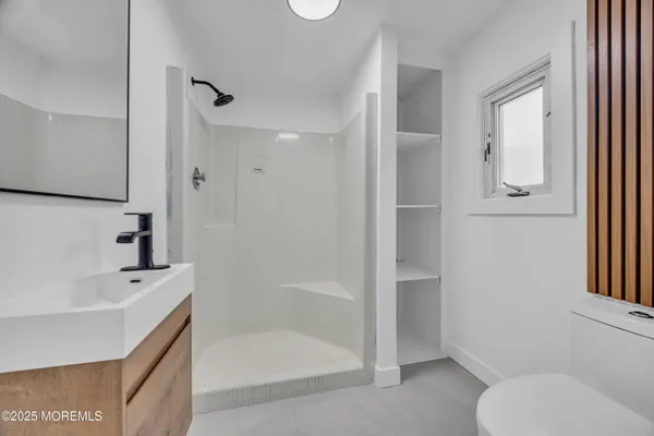 a bedroom with bed and a window