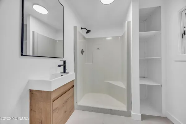 a spacious bedroom with a bed and a flat screen tv
