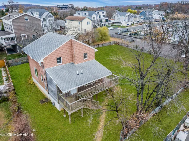 an aerial view of a house with a lake view