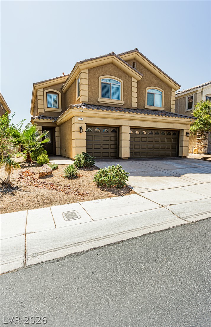 75 Tall Ruff Drive Las Vegas, NV 89148 - Photo 2 of 64 Stucco exterior and tile roofing create classic desert curb appeal with an integrated multi-car garage.