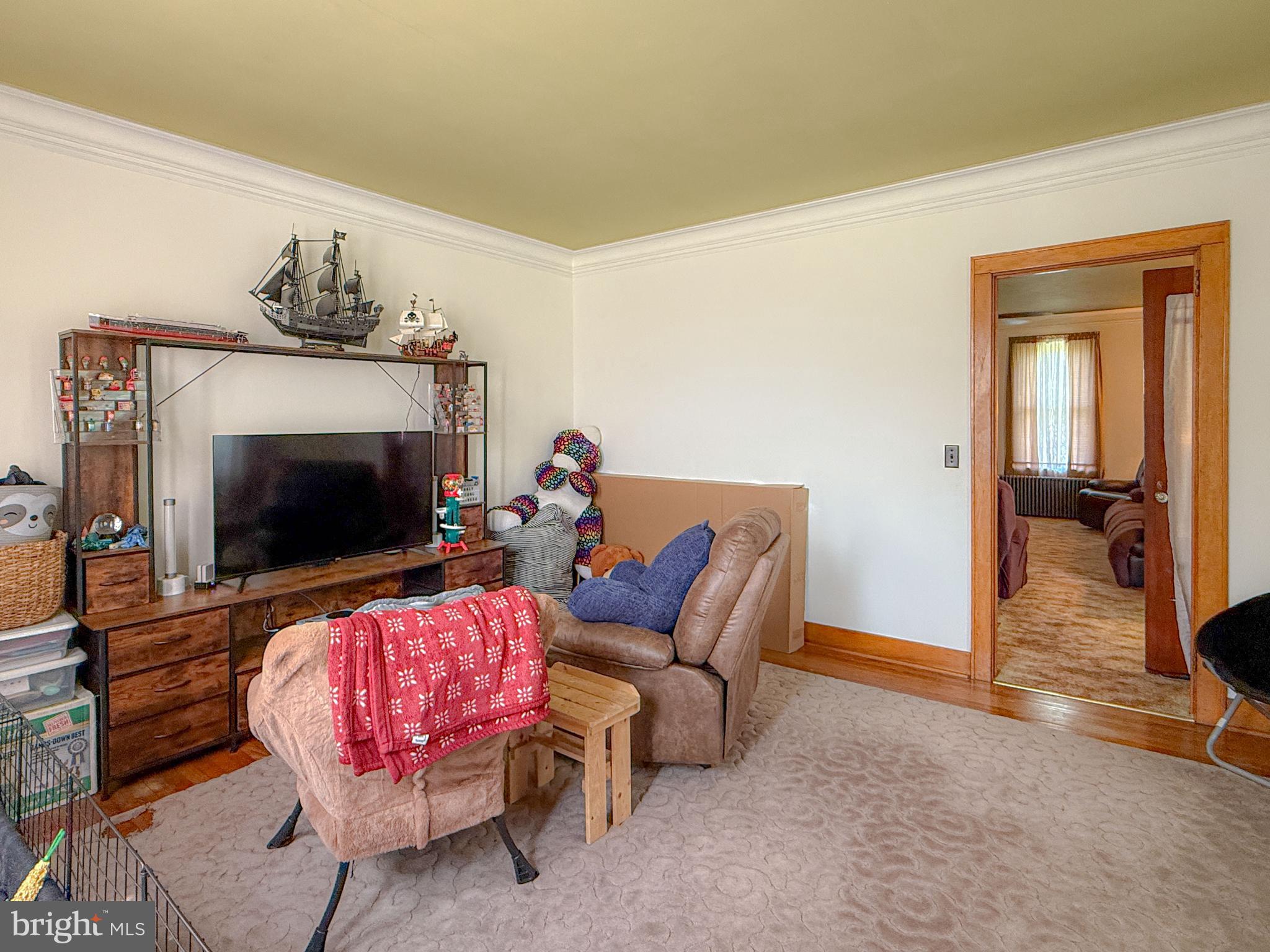 930 Osman Road Alum Bank, PA 15521 - Photo 12 of 63 a living room with furniture a flat screen tv and a fireplace