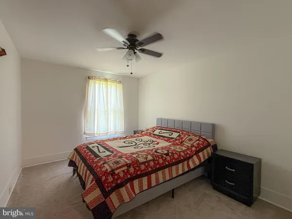 a bedroom with furniture and a chandelier