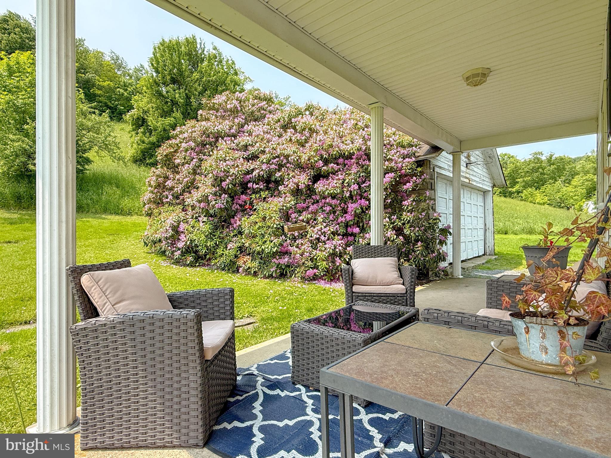 930 Osman Road Alum Bank, PA 15521 - Photo 30 of 63 a view of an outdoor dining space with a table and chairs