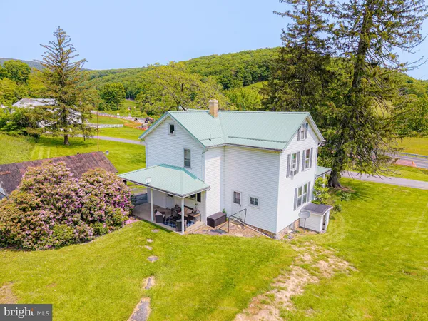 a view of a house with a yard and sitting area