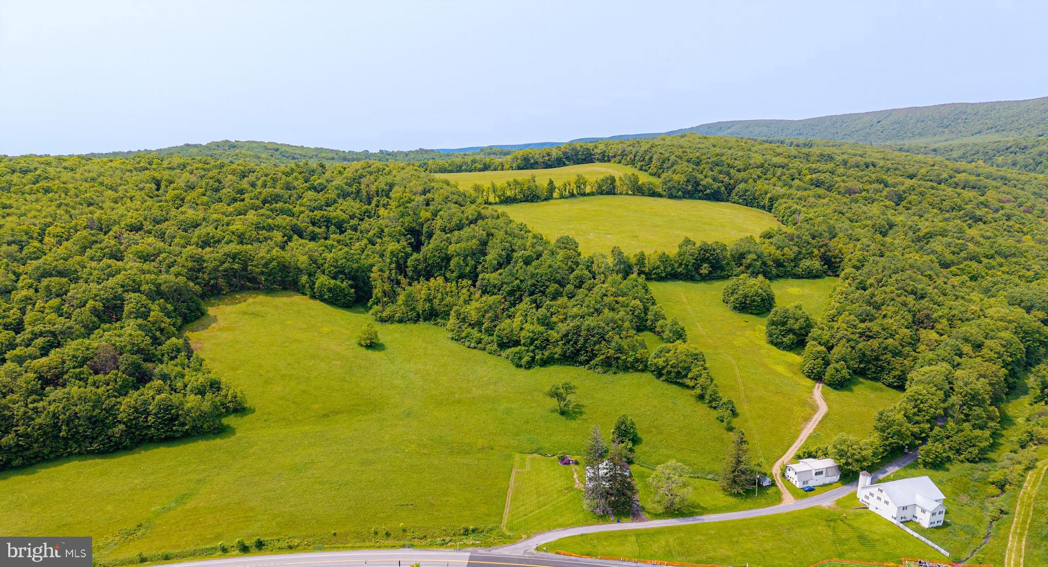 930 Osman Road Alum Bank, PA 15521 - Photo 49 of 63 a view of a lake with a mountain in the background